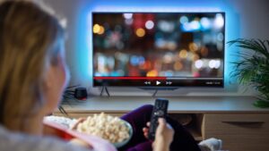 woman watches video on tv at home